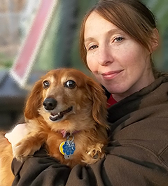 woman holding happy dog