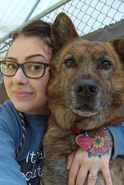 Staff member hugging dog