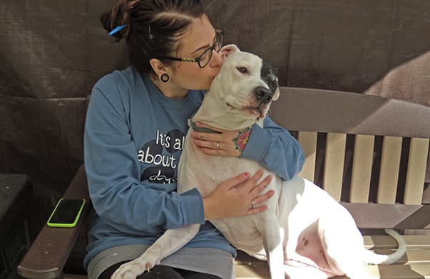 employment-staff-member-hugging-dog-crop Staff member hugging a dog