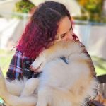 Woman snuggling with dog