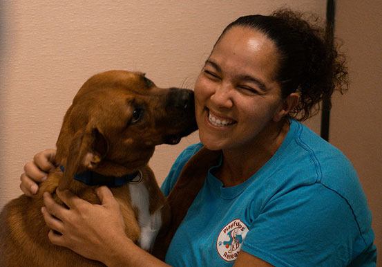 Dog kissing a woman's face