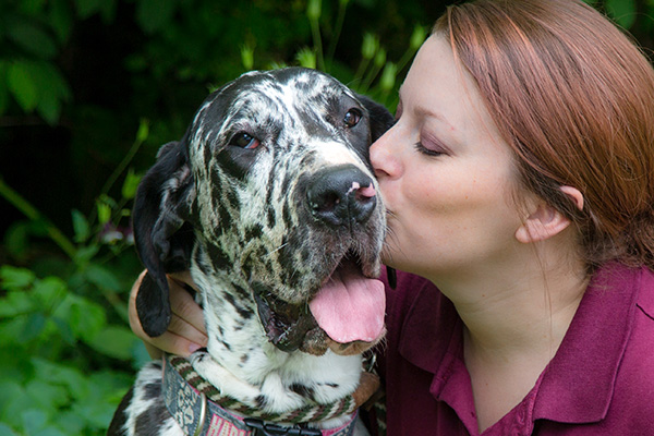 woman kissing dog