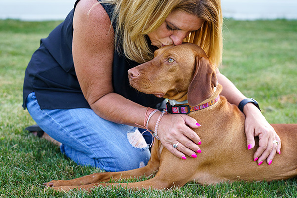 woman hugging dog